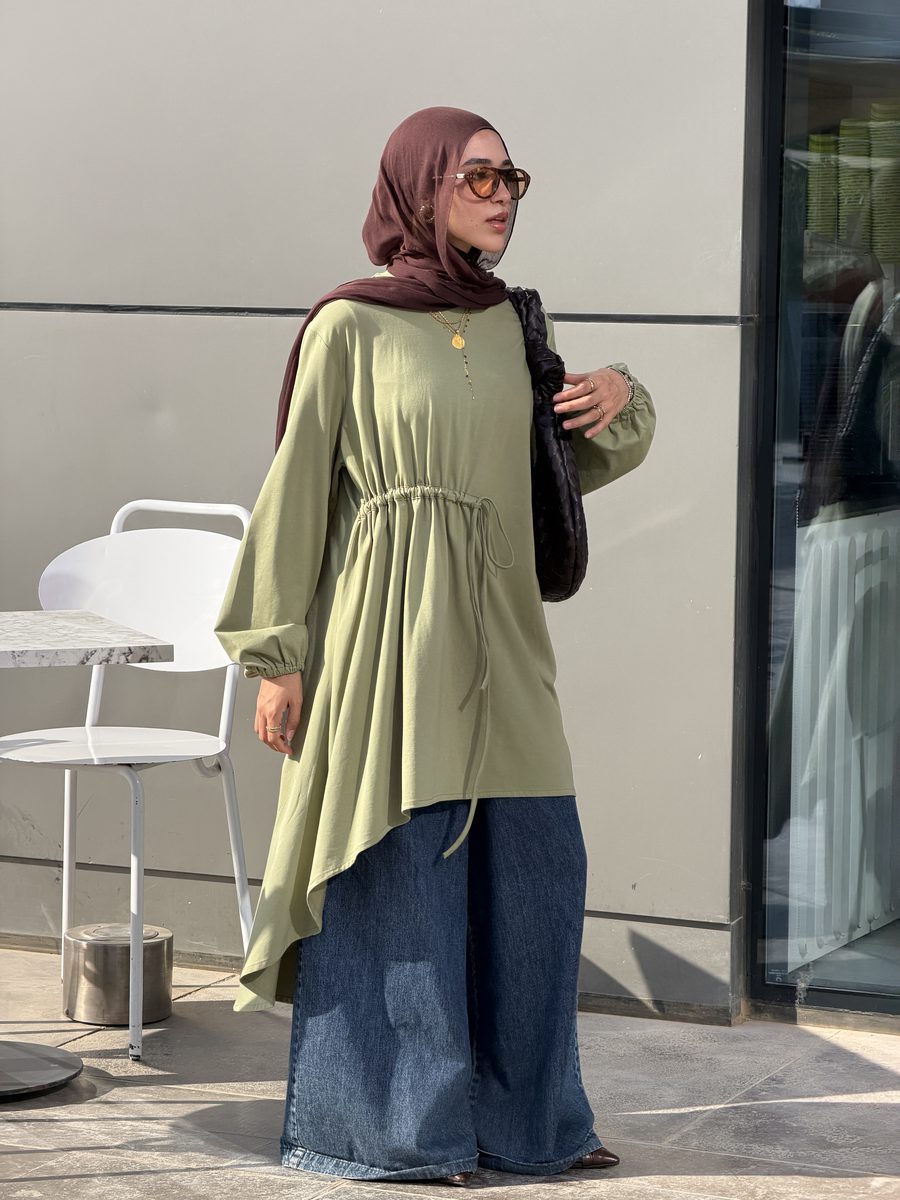 Boshra for The Black Closet in a sage tunic